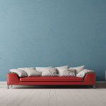 Interior of living room with a red sofa in front of a blue wall (3D Rendering)