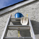 Painting Materials on Ladder Against Home Wall